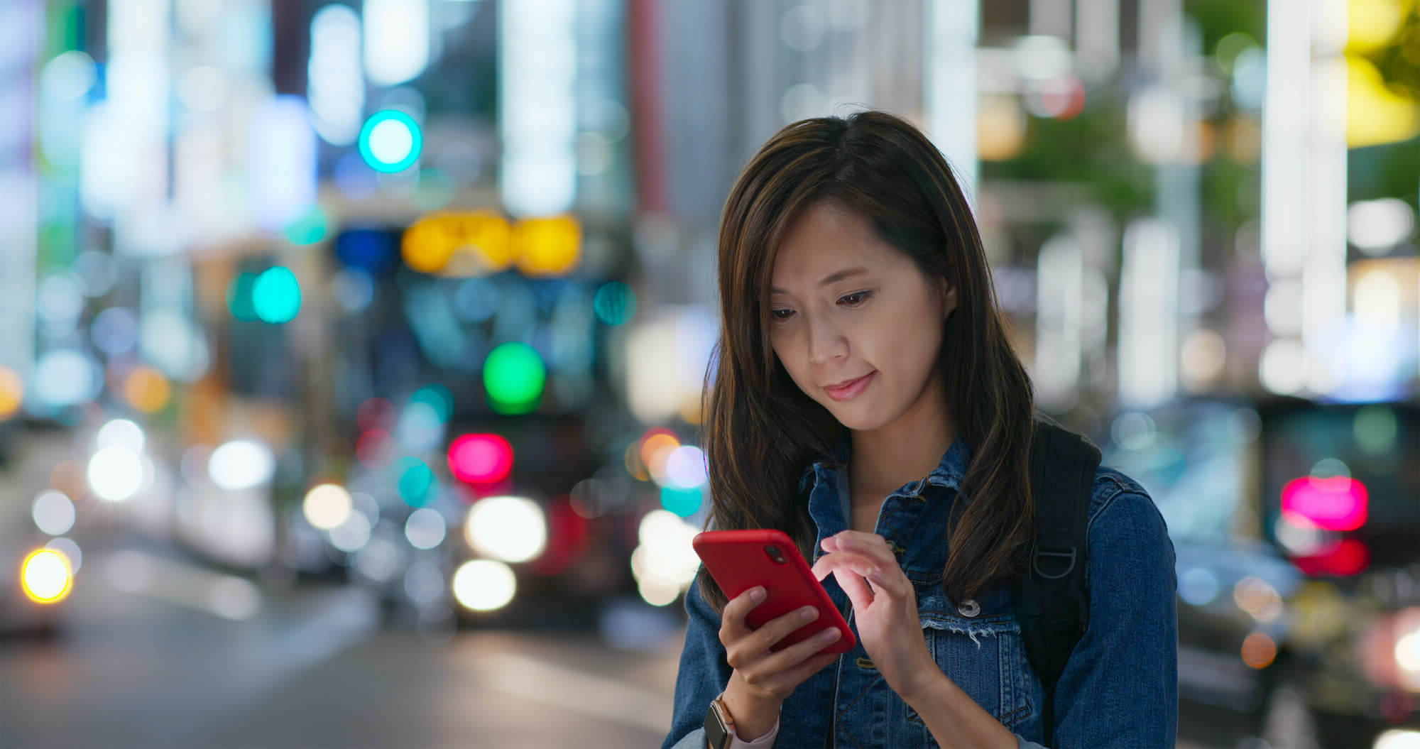 Photo of woman using her digital business on her phone